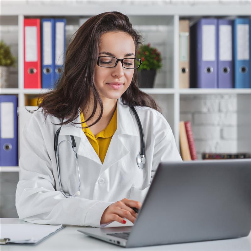 attractive-female-doctor-working-on-her-laptop-in-2023-11-27-04-58-14-utc